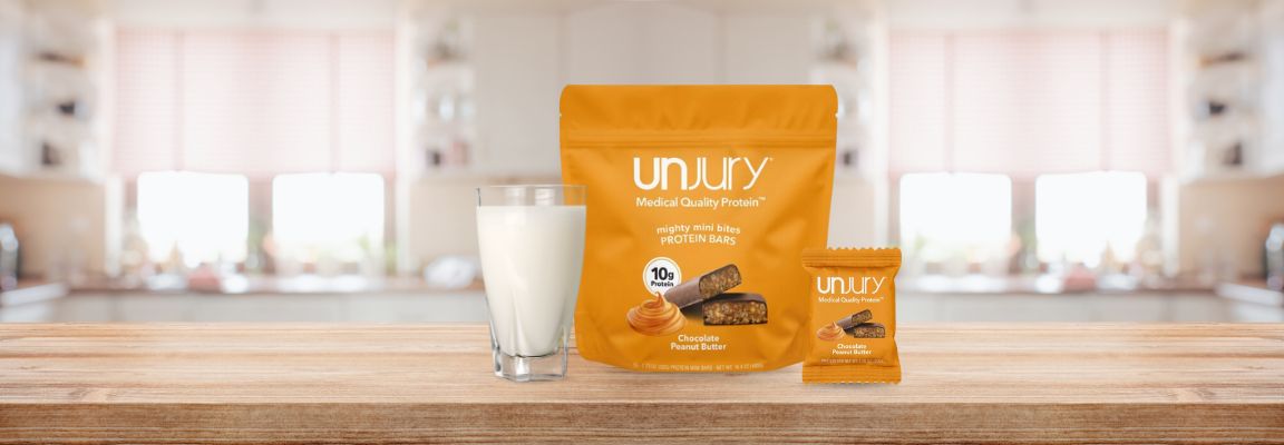 Unjury Chocolate Peanut Butter Protein Bar Bag and individual bar.