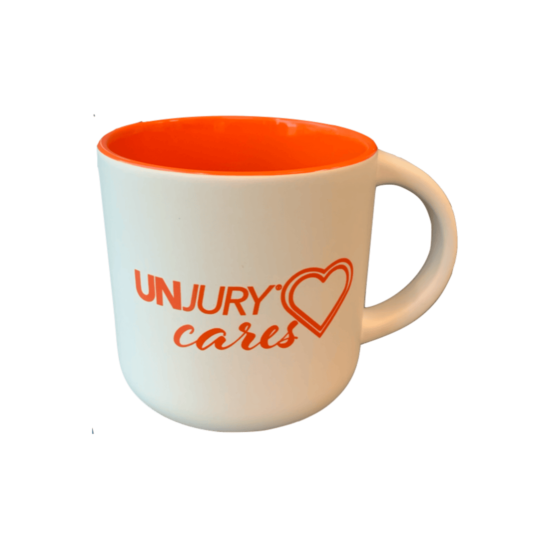 White and orange Unjury Cares Coffee Mug
