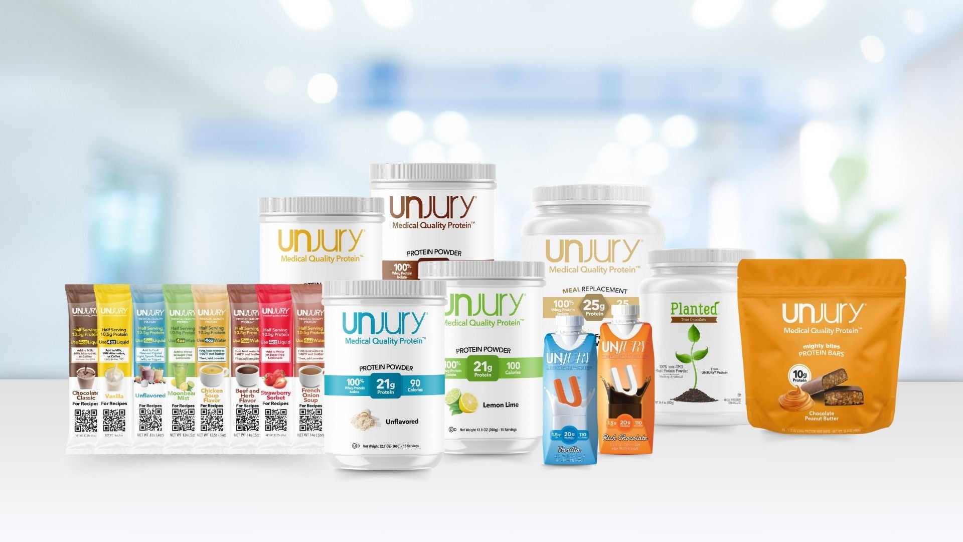 Unjury products including protein powder, protein bars, ready-to-drink shakes, and meal replacement powders. 